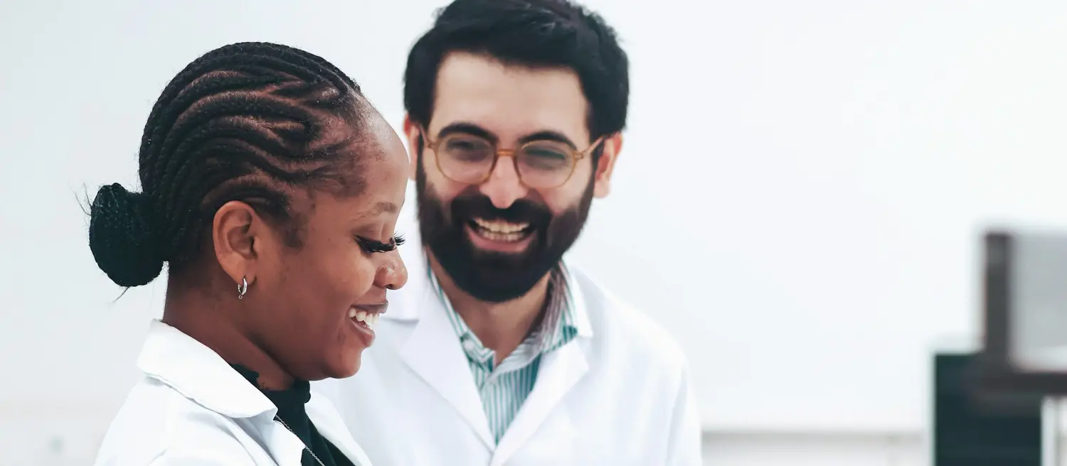 Two scientists working together in a bright laboratory